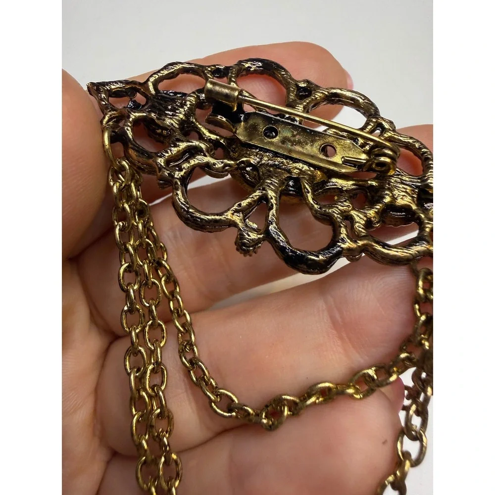 Ornate Gold Tone Filigree Brooch Faux Pearls Clear Cabochon and Triple Chain